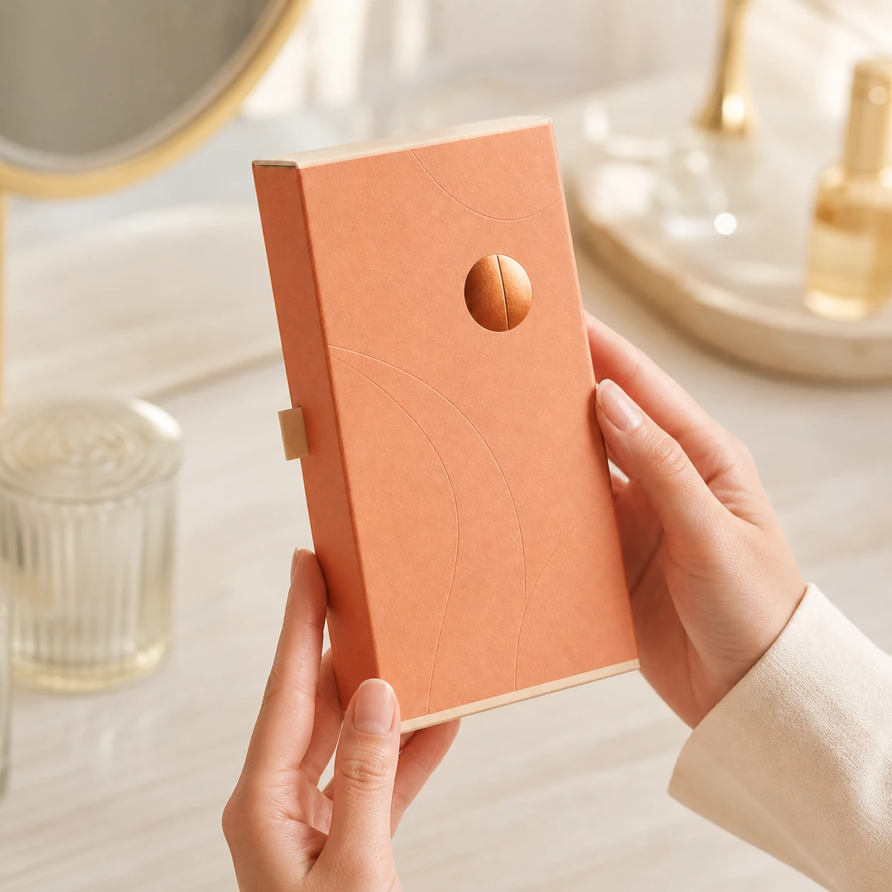 Apricot perfume carton held by hand